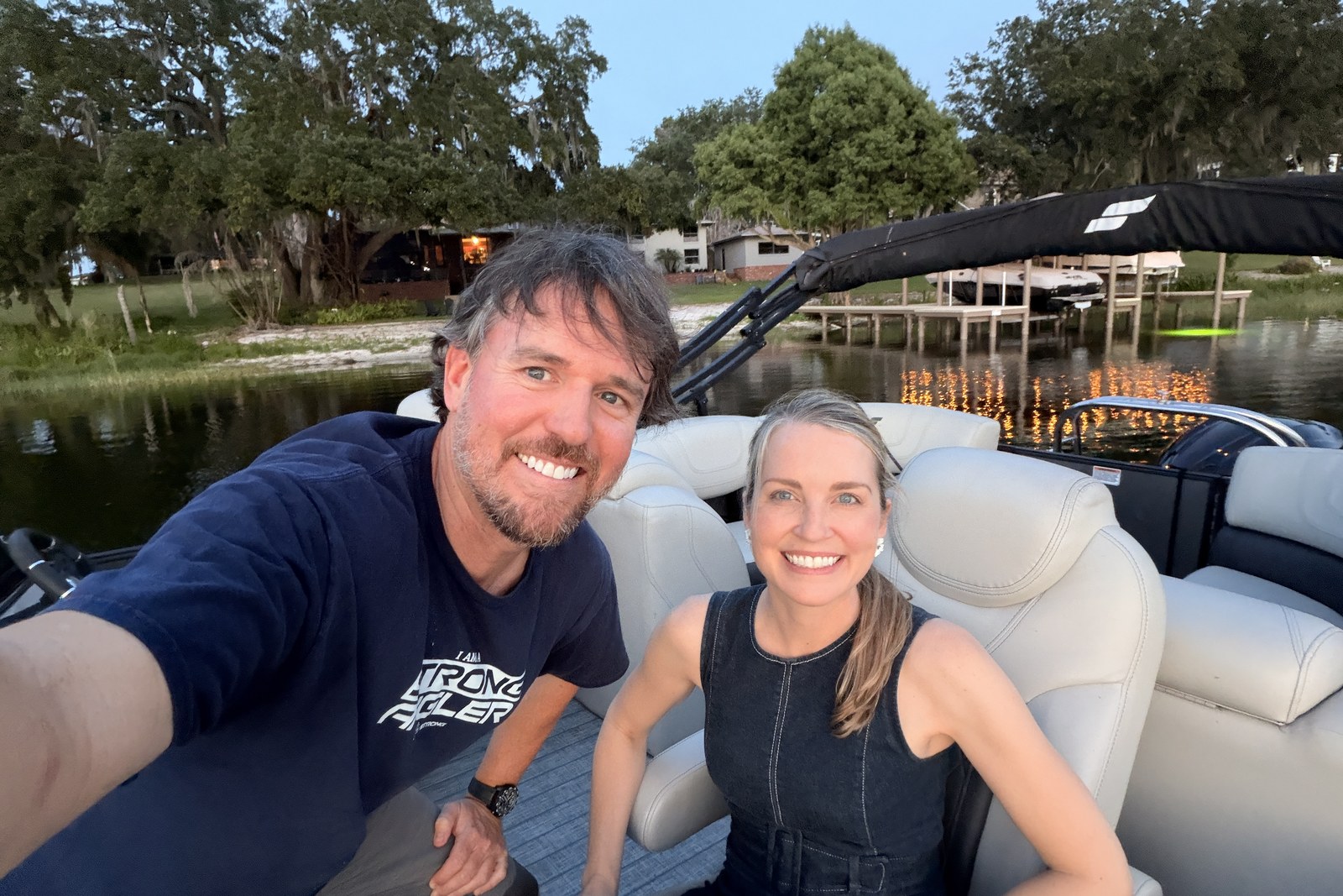 Joe Simonds and his wife on their boat at sunset on Lake Eloise in Winter Haven, Florida